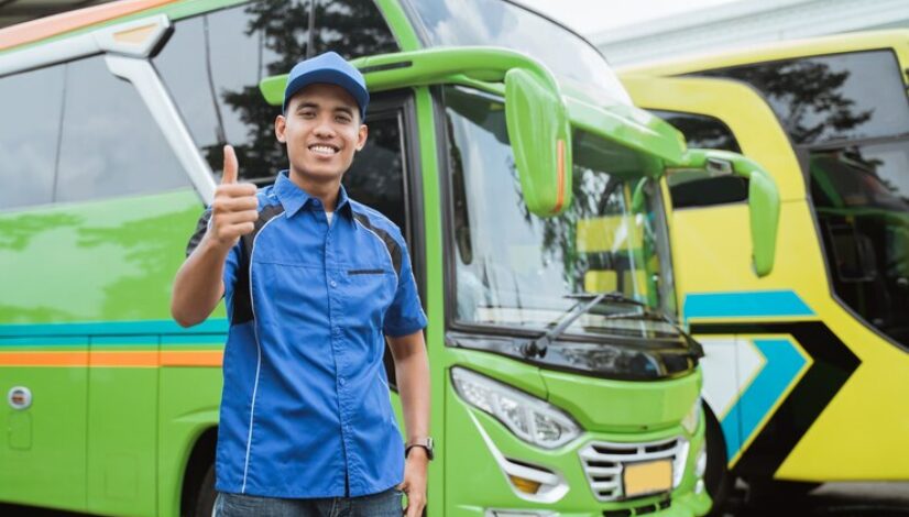 bus-driver-uniform-hat-smiles-with-thumbs-up-against-background-bus_8595-22063
